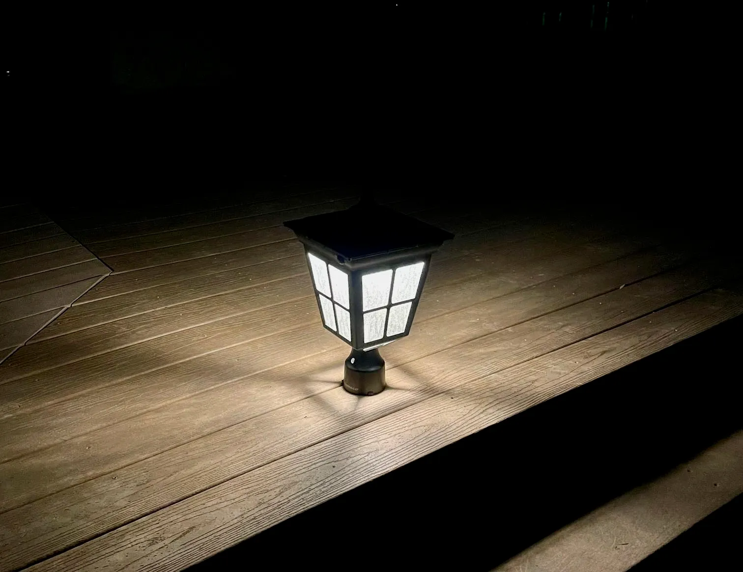 Kemeco LED Cast Aluminum Solar Post Light Fixture on picnic table lit up at night