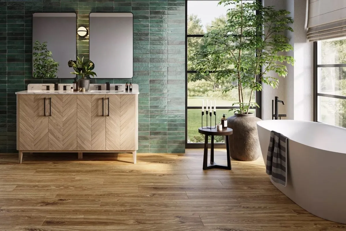 A roomy bathroom with green tiled walls and waterproof laminate flooring.