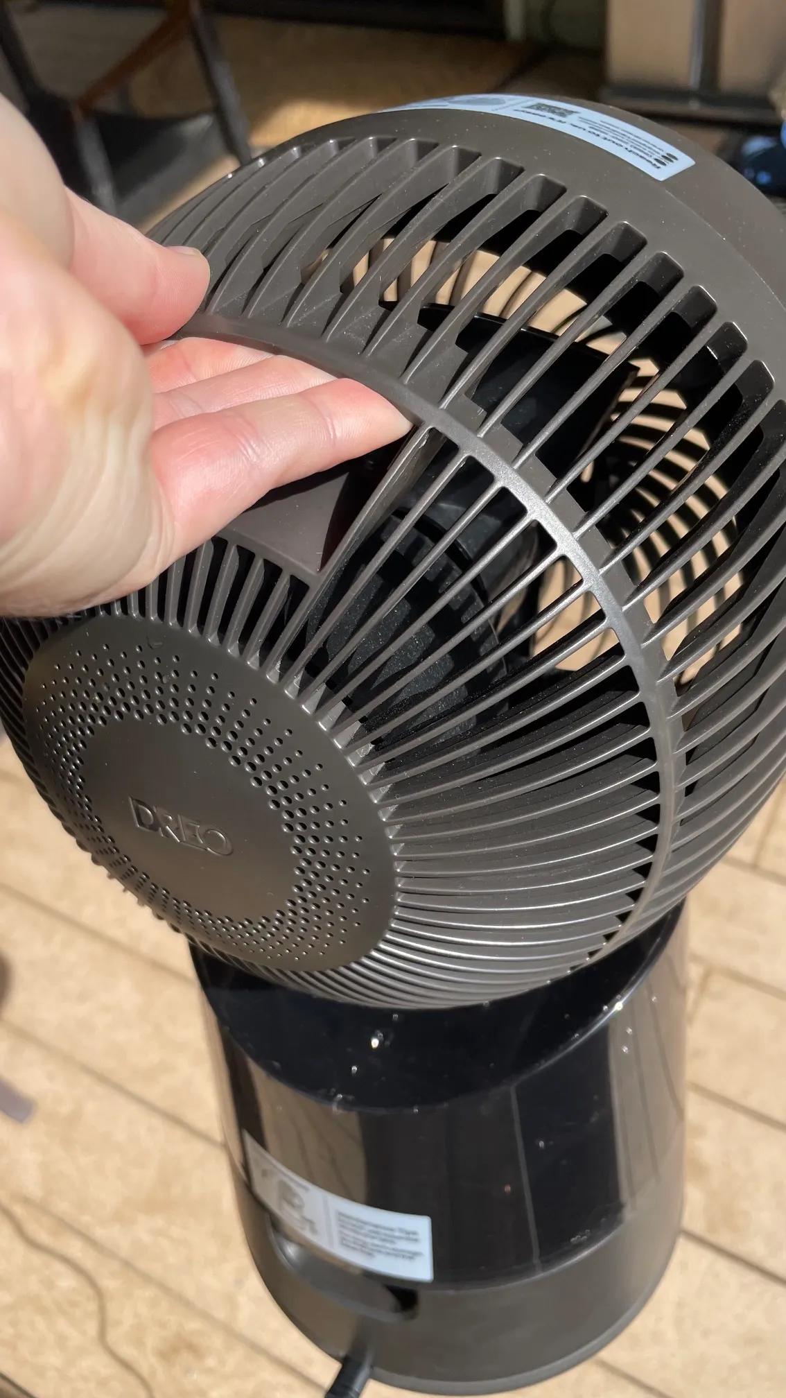 A person using the carry handle on Dreo 516S TurboCool Misting Fan during testing