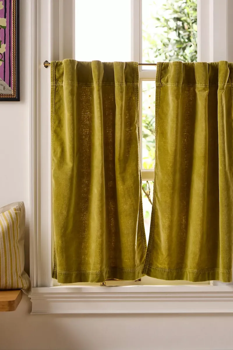 A set of olive-colored velvet cafe curtains. 
