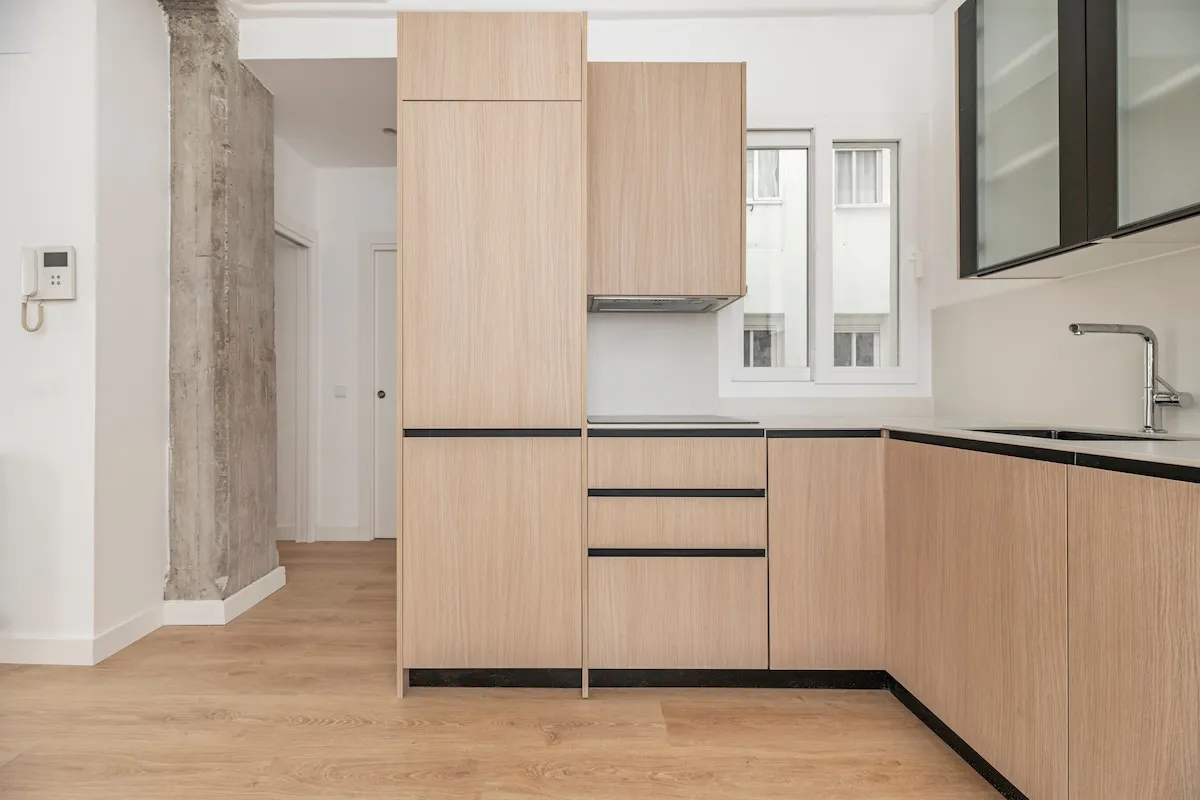 A large oak pantry-sized cabinet in a modern kitchen.