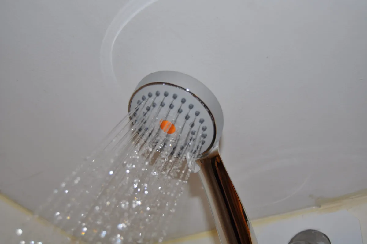 TheHO2ME High-Pressure Handheld Shower Head in use during testing.