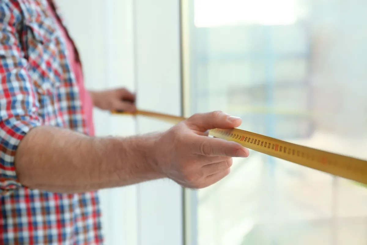 Man measuring window, closeup view.