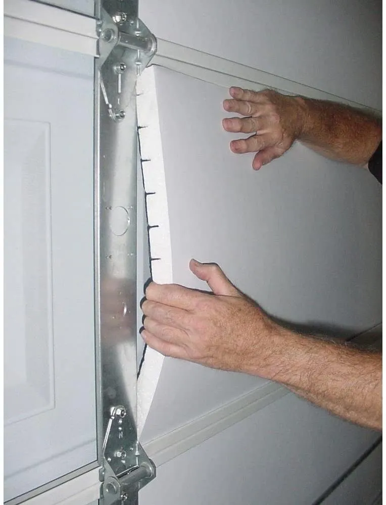 Insulating a garage door with foam boards.