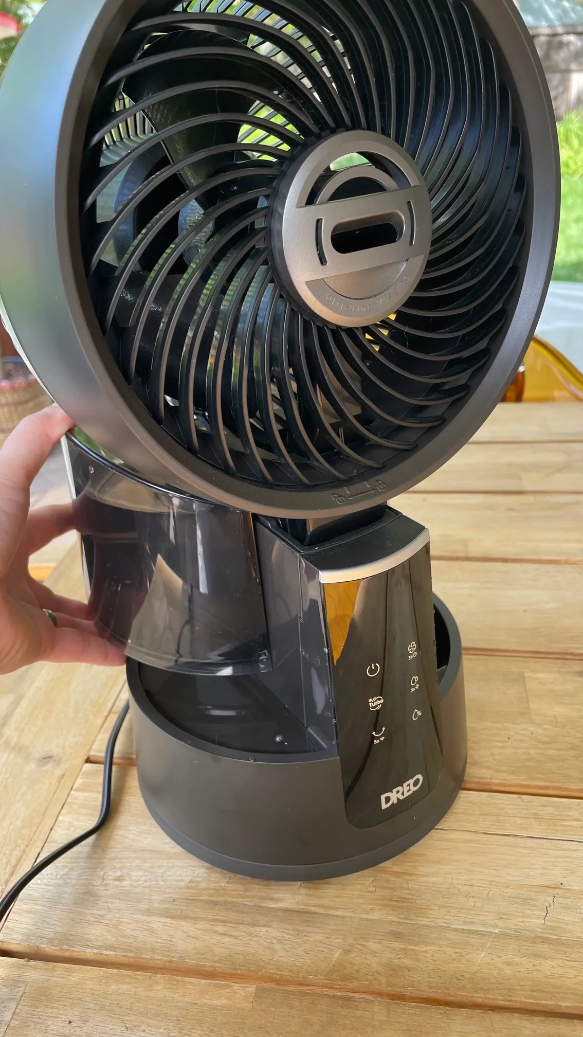 A product tester inserting the water reservoir on the Dreo 516S TurboCool Misting Fan