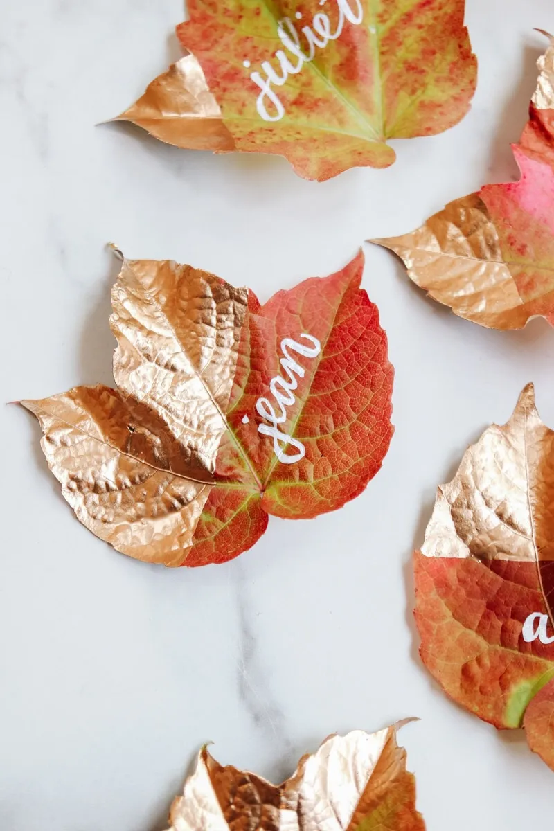 Fall leaves dipped in gold paint and personalized to be used as placecards.
