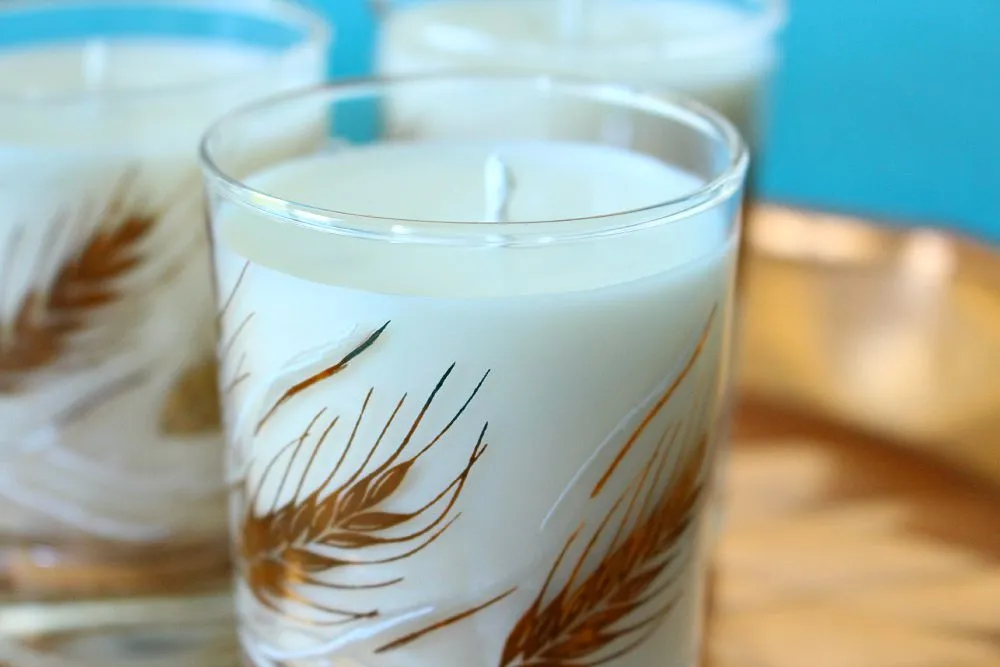 Homemade soy candle in a class candle holder with a wheat motif.