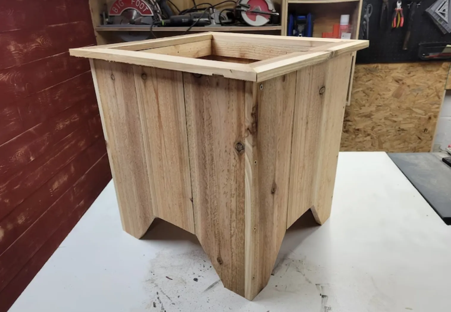 large wooden planter box on top of table in workshop