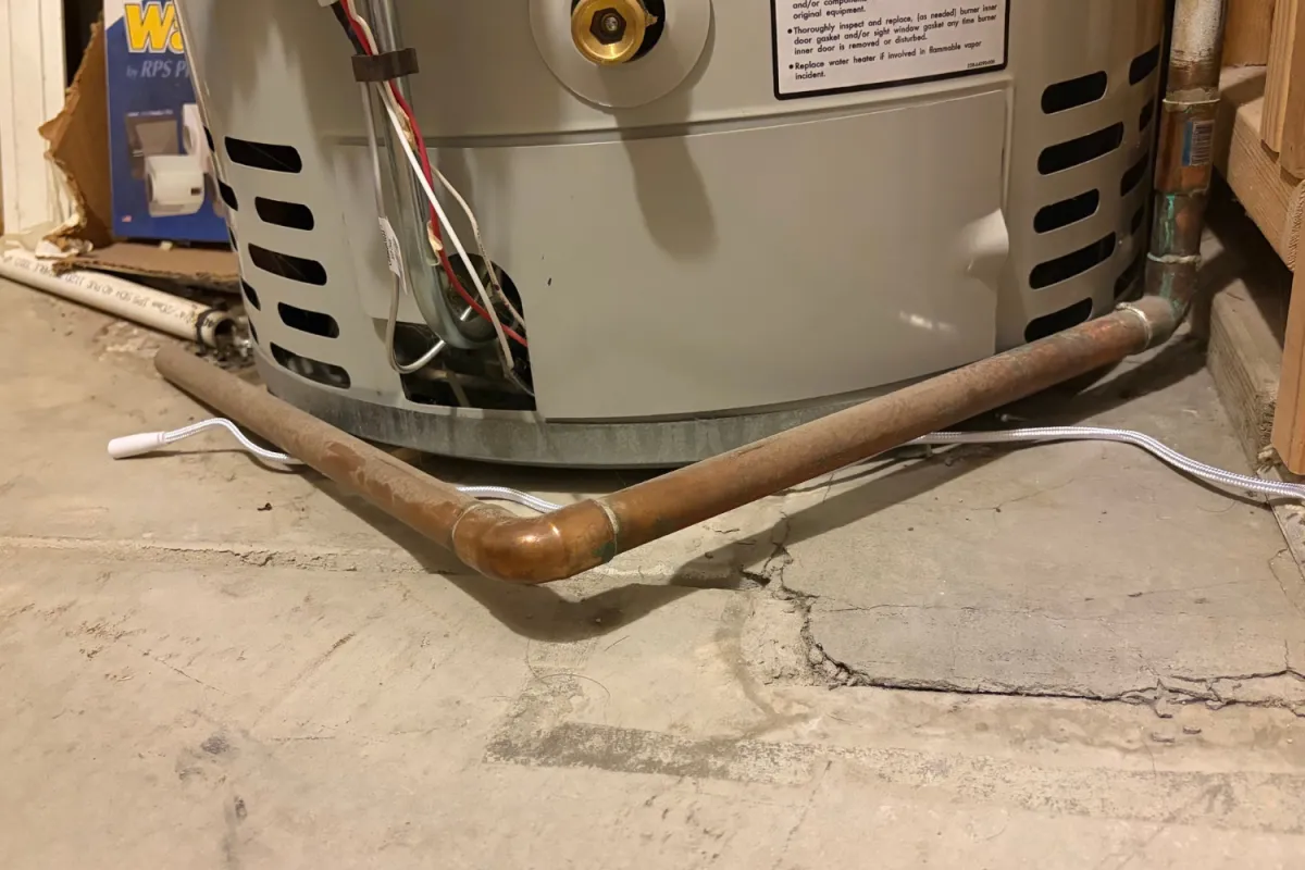 Eve Water Guard Smart Water Leak Detector around water heater during testing