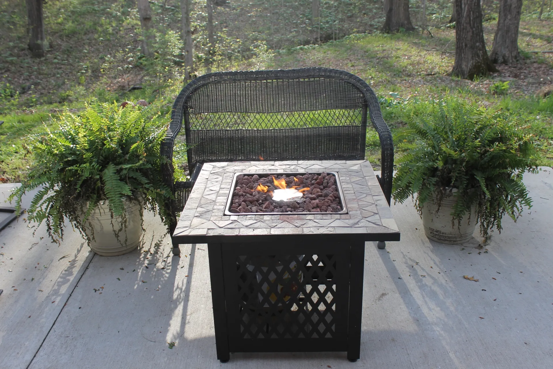 Endless Summer LP Gas Slate Tile Mantel Fire Pit in a garden