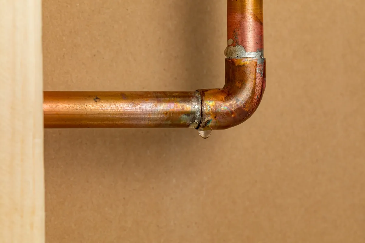 Exposed copper pipe indoors that is leaking.