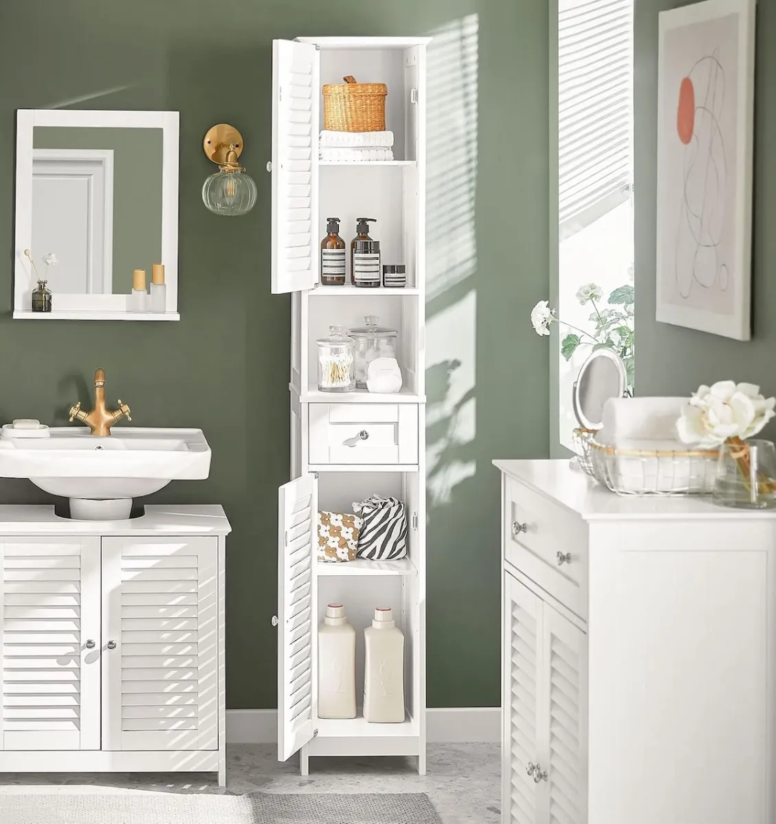 Haotian white tall bath cabinet with louvered doors that are open, in a bathroom painted dark olive green.
